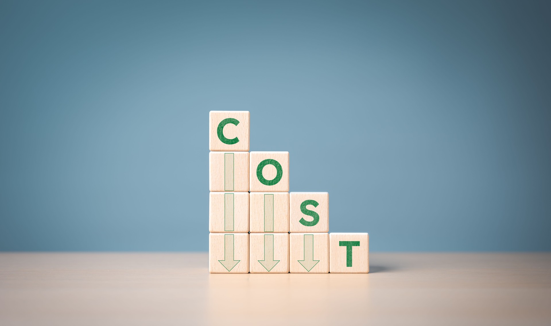 Lean optimize manufacturing and Cost reduction management concept. Decrease company expenses to maximize profits. Stacked wooden cube with green word cost and down arrow icons. Business improvement.
